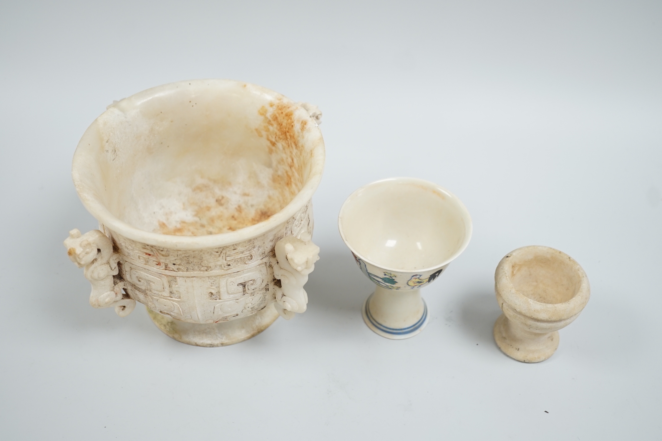 A Chinese burnt jade or hardstone censer, a stone cup and a doucai stem cup, censor 12cm high